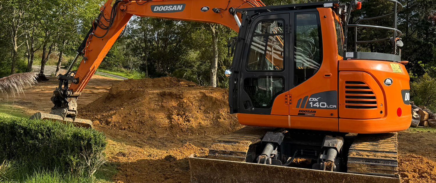 image of an excavator on a rural property